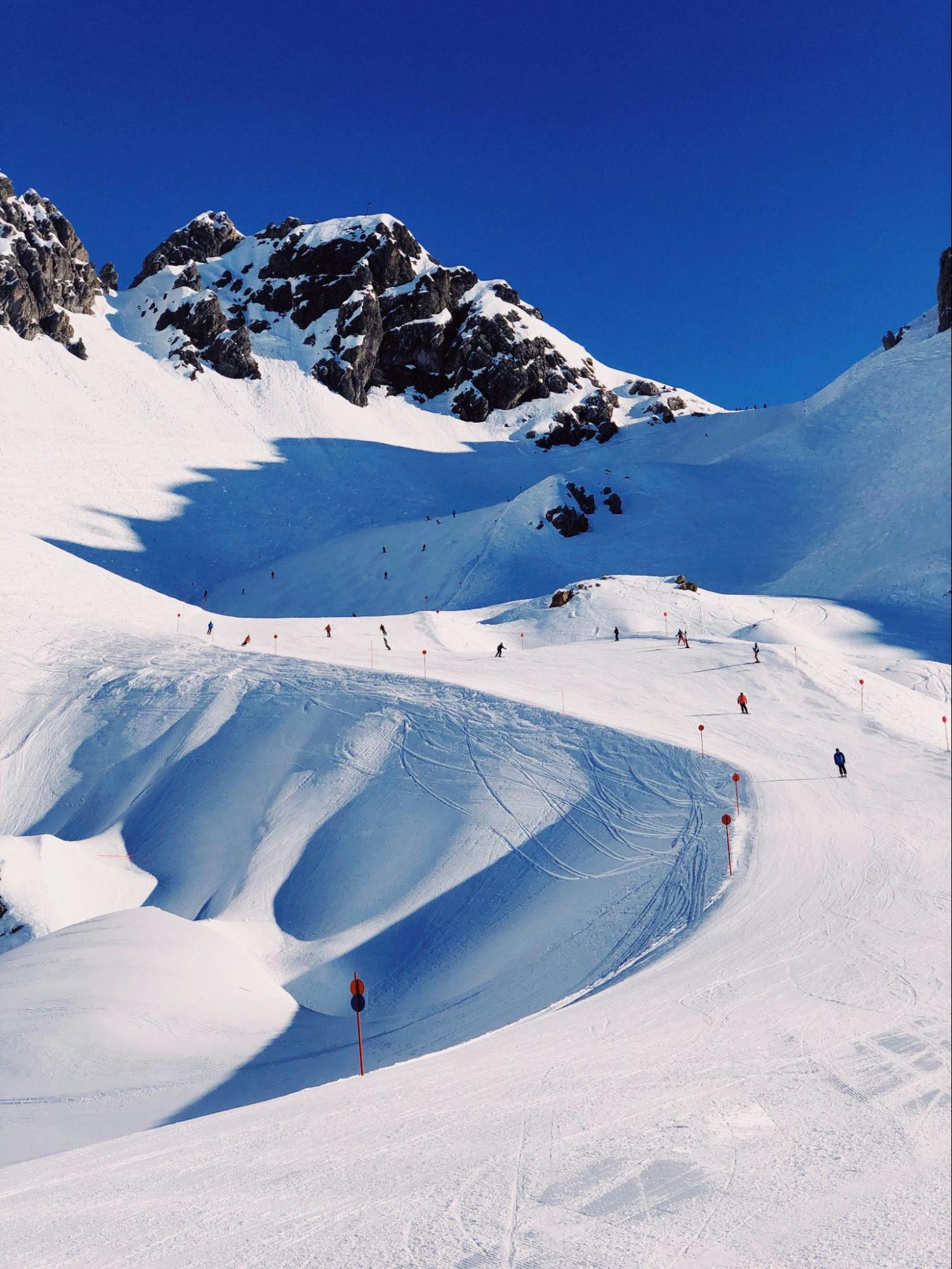 Several skiers on a mountain slope in Austria.